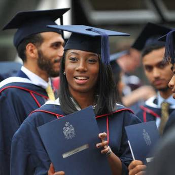 female-graduate-surrounded-by-male-graduates
