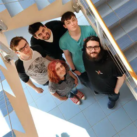 five-games-designers-looking-up-from-the-bottom-of-a-stairwell