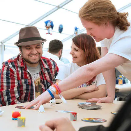 games-design-three-students-at-Brunel-Festival-looking-at-a-board-game