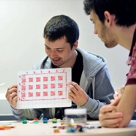 two-male-games-design-students-with-a-prototype-board-game