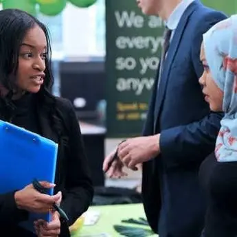 two-women-talking-at-a-careers-fair