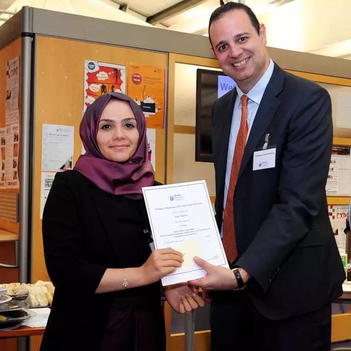 Head of Brunel Law School Arad Reisberg presenting a student with a certificate