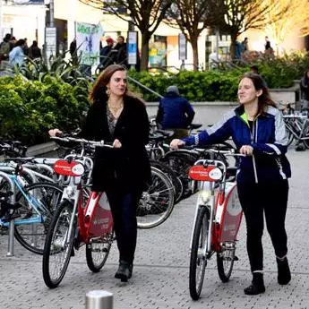Brunel student walking with Santander Bikes