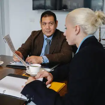 older man consulting young business woman