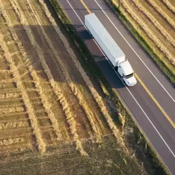 Farm with a large cargo truck on the road