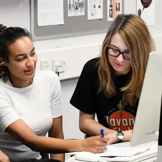 female students working on a desktop