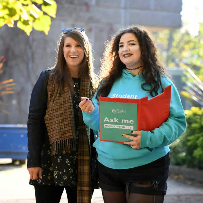 female current student showing prospective student around the campus